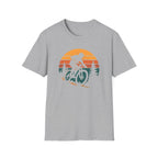 Gray t-shirt with a graphic of a person on a bike and sunset design on a white background